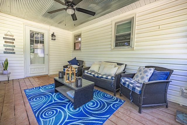 wooden terrace featuring a ceiling fan and an outdoor living space