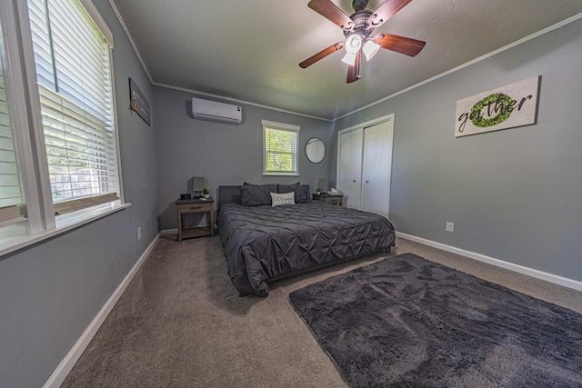 bedroom with an AC wall unit, crown molding, carpet flooring, baseboards, and a closet