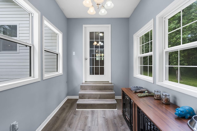 26478 Shadow Rd, Pittsburg, MO 65724 - doorway to outside featuring a chandelier, wood finished floors, and baseboards