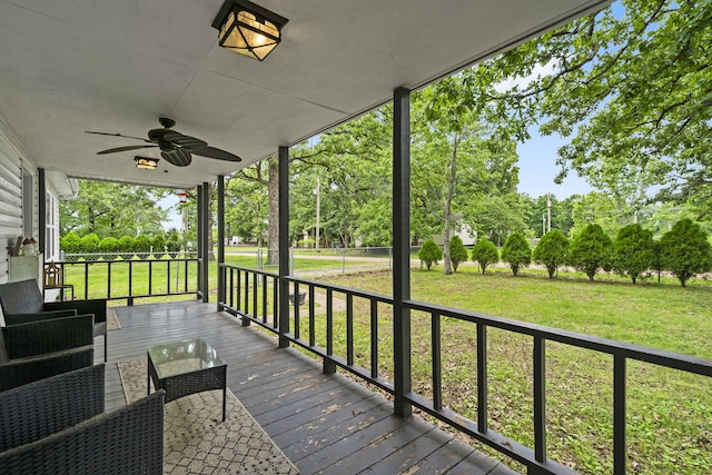 26478 Shadow Rd, Pittsburg, MO 65724 - wooden terrace featuring a ceiling fan, view of scattered trees, and a lawn