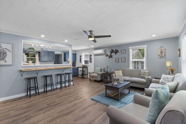 26478 Shadow Rd, Pittsburg, MO 65724 - living room featuring a wall mounted AC, ceiling fan, wood finished floors, baseboards, and recessed lighting