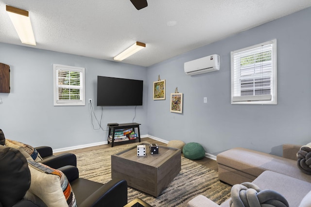 26478 Shadow Rd, Pittsburg, MO 65724 - living area featuring a wall mounted AC, baseboards, a textured ceiling, and wood finished floors
