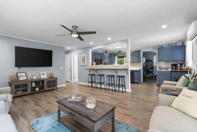 26478 Shadow Rd, Pittsburg, MO 65724 - living area featuring ceiling fan, light wood-style flooring, a wall unit AC, recessed lighting, and crown molding