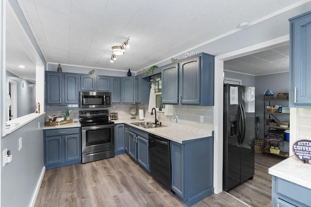 26478 Shadow Rd, Pittsburg, MO 65724 - kitchen with appliances with stainless steel finishes, a sink, crown molding, light wood finished floors, and backsplash