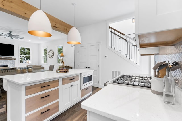 452 Rest Haven Ln, Blue Eye, MO 65611 - kitchen featuring white microwave, dark wood finished floors, open floor plan, ceiling fan, and decorative backsplash