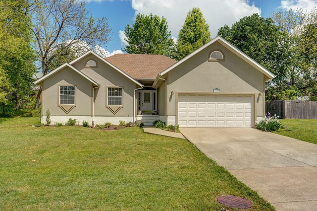 3809 W El Castile St, Springfield, MO 65807 - ranch-style house with concrete driveway, an attached garage, and stucco siding