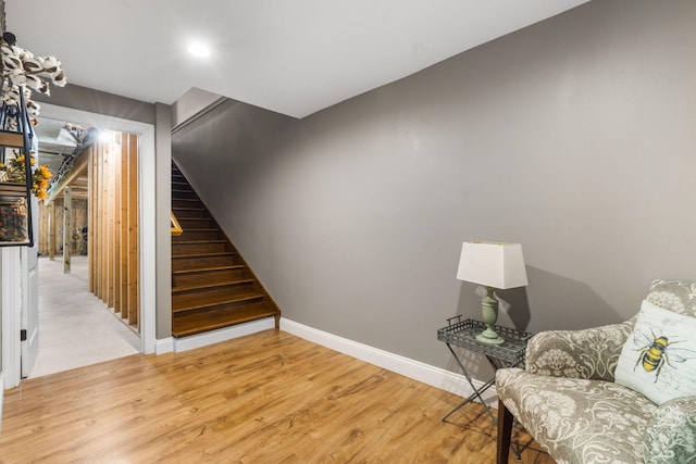 103 Dogwood Ct, Saddlebrooke, MO 65630 - living area featuring stairway, light wood-style flooring, and baseboards