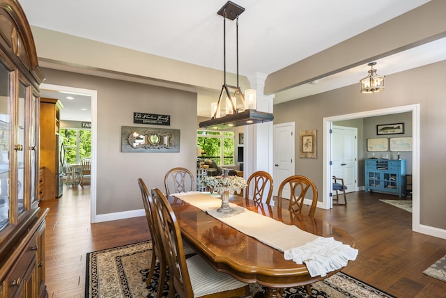 103 Dogwood Ct, Saddlebrooke, MO 65630 - dining area featuring baseboards, dark wood-type flooring, and a chandelier