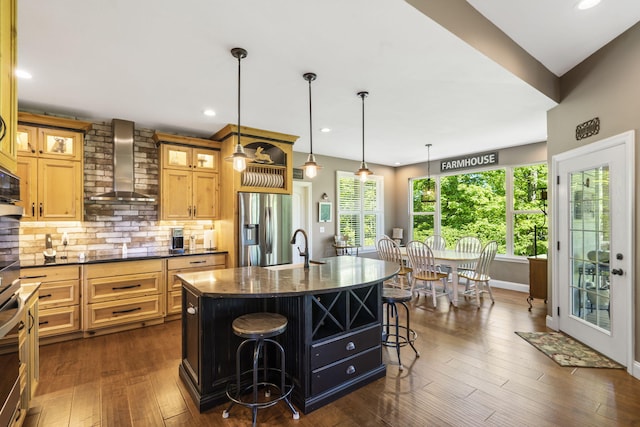 103 Dogwood Ct, Saddlebrooke, MO 65630 - kitchen with wall chimney range hood, stainless steel fridge with ice dispenser, a breakfast bar, a sink, and decorative backsplash