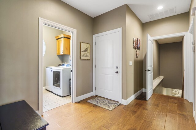 103 Dogwood Ct, Saddlebrooke, MO 65630 - foyer featuring washer and clothes dryer, light wood-type flooring, and baseboards