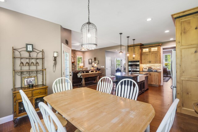 103 Dogwood Ct, Saddlebrooke, MO 65630 - dining area with dark wood-style flooring, a chandelier, recessed lighting, and baseboards