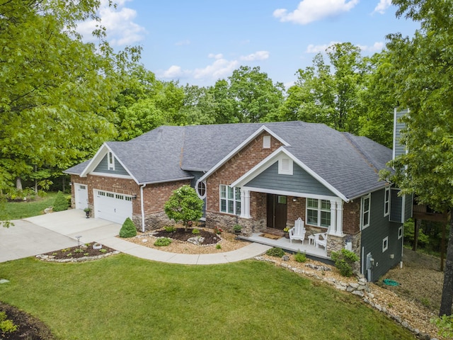 103 Dogwood Ct, Saddlebrooke, MO 65630 - craftsman-style house with a porch, roof with shingles, concrete driveway, a front yard, and an attached garage