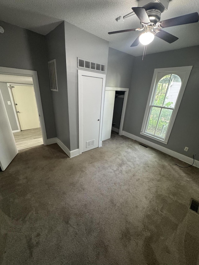 2007 N Travis Ave, Springfield, MO 65803 - unfurnished bedroom with carpet flooring, a textured ceiling, baseboards, ceiling fan, and a closet