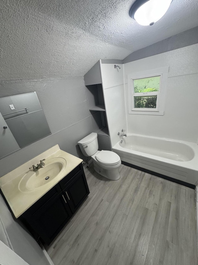 2007 N Travis Ave, Springfield, MO 65803 - bathroom with wood finished floors, a textured ceiling, toilet, vanity, and tub / shower combination