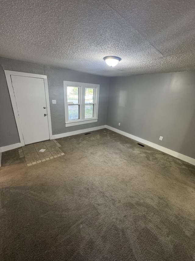 2007 N Travis Ave, Springfield, MO 65803 - unfurnished room featuring a textured ceiling, baseboards, and carpet flooring