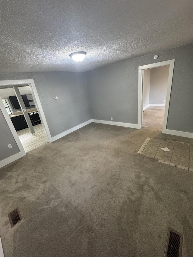 2007 N Travis Ave, Springfield, MO 65803 - carpeted empty room with a textured ceiling and baseboards
