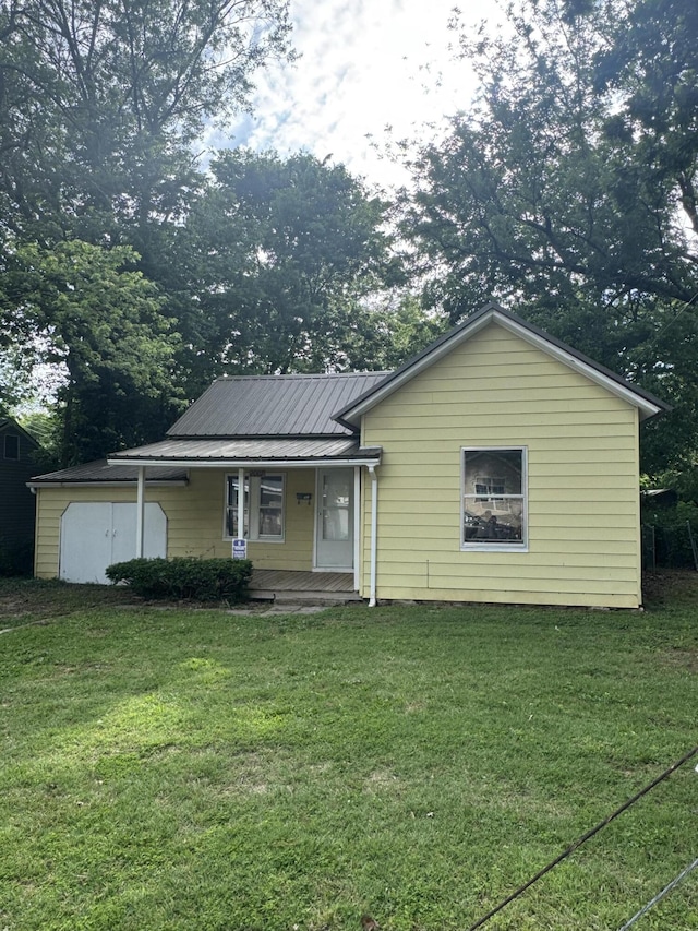 2007 N Travis Ave, Springfield, MO 65803 - view of front of property with a front lawn, covered porch, and metal roof