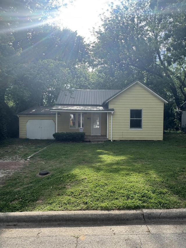 2007 N Travis Ave, Springfield, MO 65803 - view of front of home featuring a front lawn, a porch, and metal roof