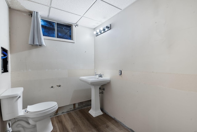 3662 N Farm Rd Unit 127, Springfield, MO 65803 - half bathroom with wood finished floors, toilet, a paneled ceiling, and a sink