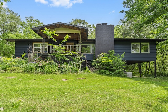 3662 N Farm Rd Unit 127, Springfield, MO 65803 - back of house with a chimney, a yard, and a wooden deck