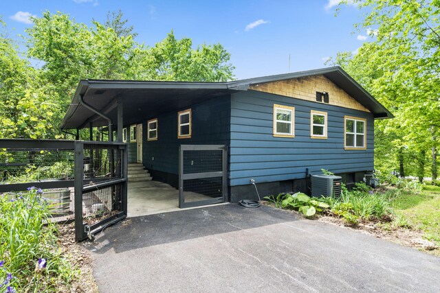 3662 N Farm Rd Unit 127, Springfield, MO 65803 - view of side of property with central AC unit, driveway, and a carport
