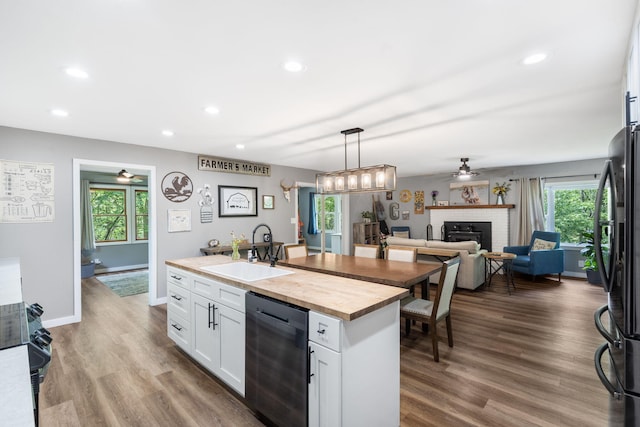 3662 N Farm Rd Unit 127, Springfield, MO 65803 - kitchen with a sink, dishwasher, wooden counters, a ceiling fan, and freestanding refrigerator
