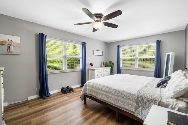 3662 N Farm Rd Unit 127, Springfield, MO 65803 - bedroom featuring wood finished floors, baseboards, and a ceiling fan