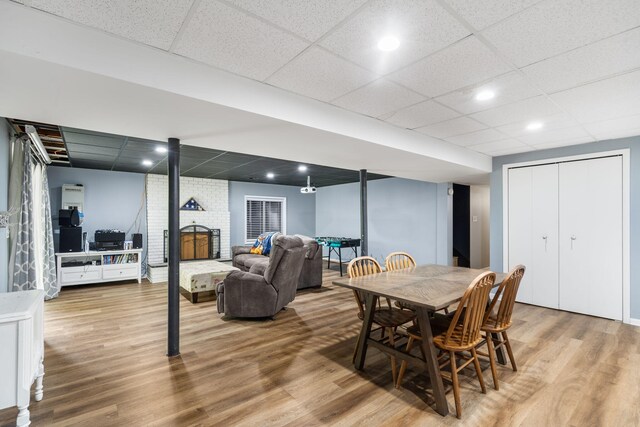 3662 N Farm Rd Unit 127, Springfield, MO 65803 - dining room with a paneled ceiling, a brick fireplace, wood finished floors, and recessed lighting