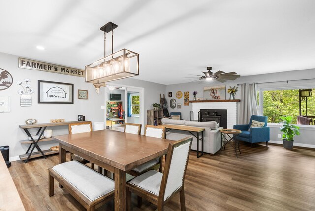 3662 N Farm Rd Unit 127, Springfield, MO 65803 - dining space with light wood-type flooring, ceiling fan, a fireplace, baseboards, and recessed lighting