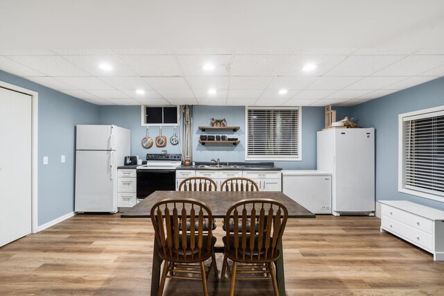 3662 N Farm Rd Unit 127, Springfield, MO 65803 - dining space with light wood-style flooring, a drop ceiling, and recessed lighting
