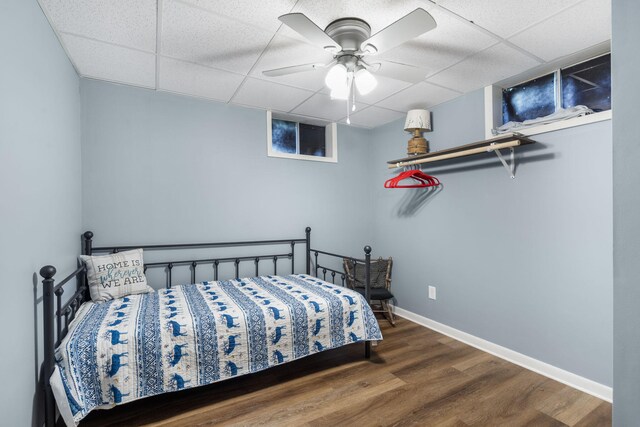 3662 N Farm Rd Unit 127, Springfield, MO 65803 - bedroom featuring wood finished floors, a drop ceiling, baseboards, and ceiling fan