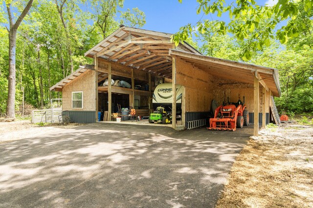 3662 N Farm Rd Unit 127, Springfield, MO 65803 - view of pole building featuring asphalt driveway and a carport