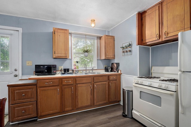 2708 N Fremont Ave, Springfield, MO 65803 - kitchen with white appliances, a sink, light countertops, dark wood-style flooring, and brown cabinets