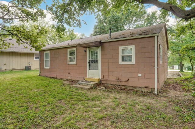 2708 N Fremont Ave, Springfield, MO 65803 - rear view of property with a yard, central AC unit, and entry steps