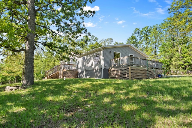 view of home's exterior with a wooden deck, stairs, and a yard