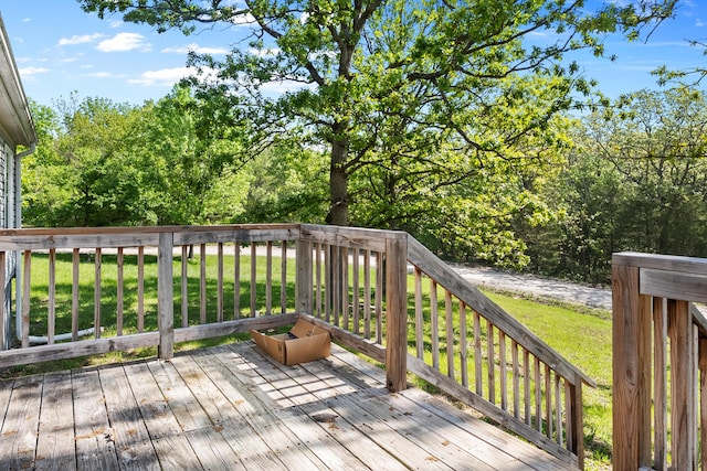 wooden terrace with a lawn
