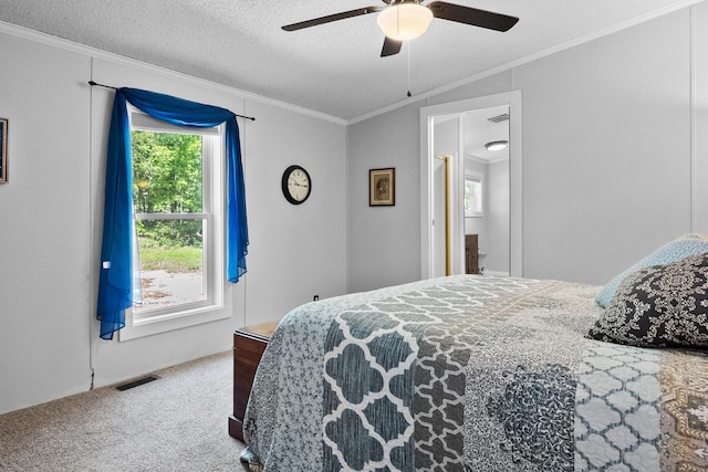 bedroom featuring carpet floors, crown molding, ceiling fan, and a textured ceiling
