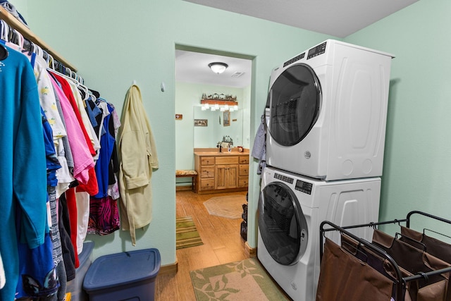 229 Grand Slam Ave, Cape Fair, MO 65624 - clothes washing area featuring stacked washer / drying machine and light wood finished floors
