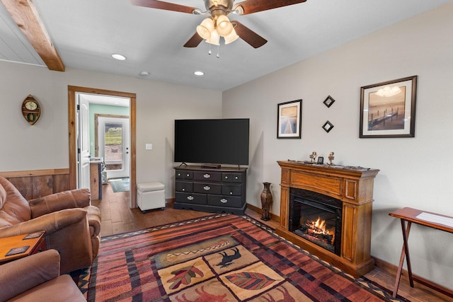 229 Grand Slam Ave, Cape Fair, MO 65624 - living area featuring wood finished floors, a ceiling fan, recessed lighting, a glass covered fireplace, and beamed ceiling