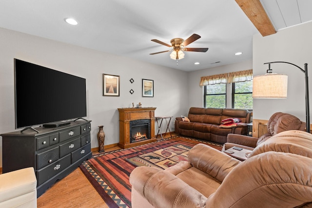 229 Grand Slam Ave, Cape Fair, MO 65624 - living room with light wood-style floors, a ceiling fan, recessed lighting, a warm lit fireplace, and baseboards