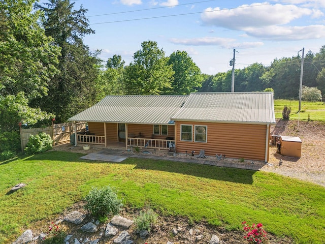 229 Grand Slam Ave, Cape Fair, MO 65624 - rear view of house with log veneer siding, metal roof, and a patio area