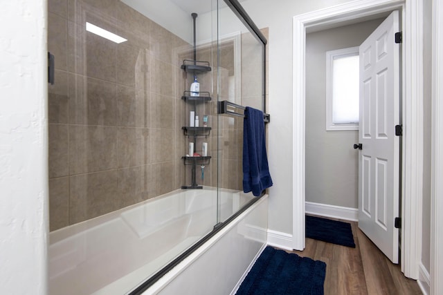 700 E Delmar St, Springfield, MO 65807 - full bathroom featuring combined bath / shower with glass door, wood finished floors, and baseboards