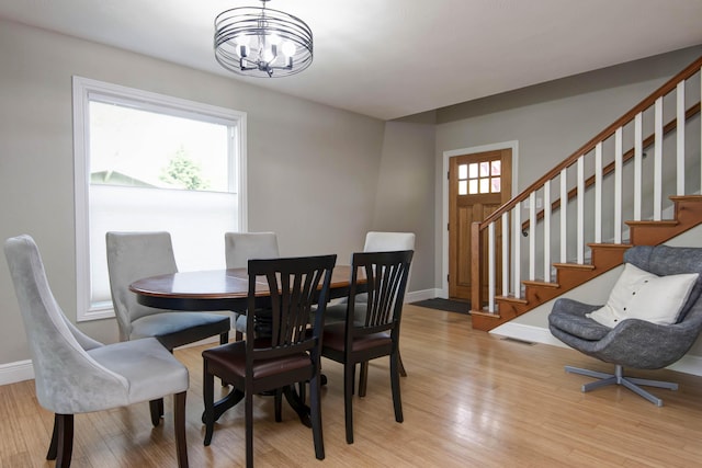 700 E Delmar St, Springfield, MO 65807 - dining space featuring stairway, light wood-type flooring, baseboards, and a chandelier