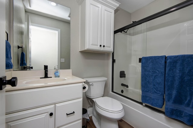700 E Delmar St, Springfield, MO 65807 - bathroom with vanity, toilet, shower / bath combination with glass door, and wood finished floors