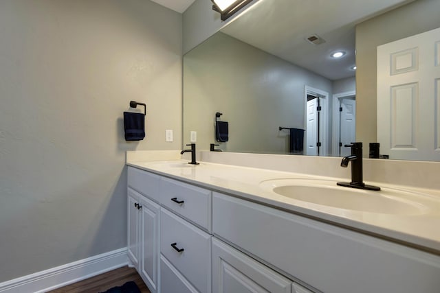 700 E Delmar St, Springfield, MO 65807 - bathroom with double vanity, baseboards, wood finished floors, and recessed lighting
