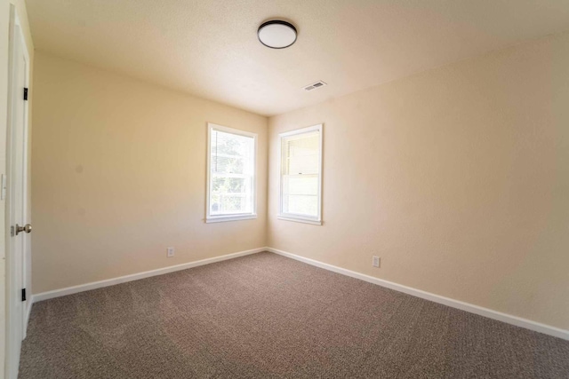 empty room with carpet flooring and baseboards