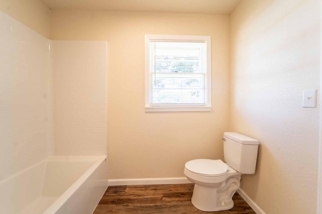 bathroom featuring toilet, wood finished floors, and baseboards