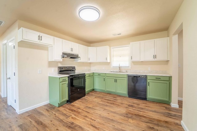 kitchen featuring black appliances, green cabinets, under cabinet range hood, and a sink