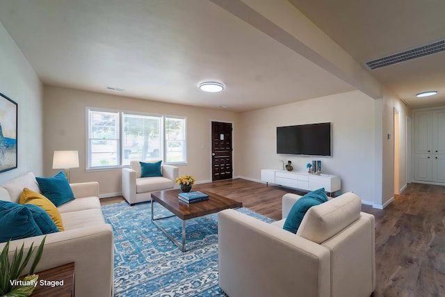 living room with baseboards and wood finished floors