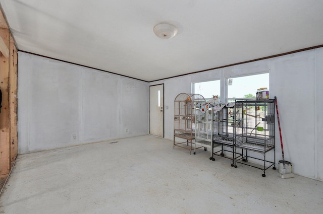 unfurnished room with unfinished concrete floors